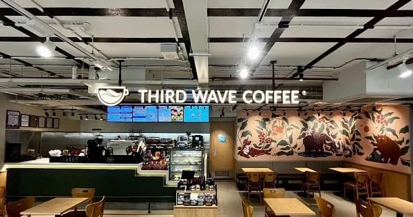 Third Wave Coffee café interior in Santacruz featuring the coffee counter, seating area and branded wall décor