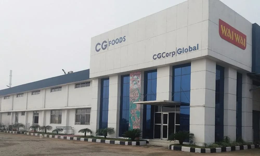 CG Foods manufacturing facility featuring CG Foods, CG Corp Global, and Wai Wai branding on the building exterior.